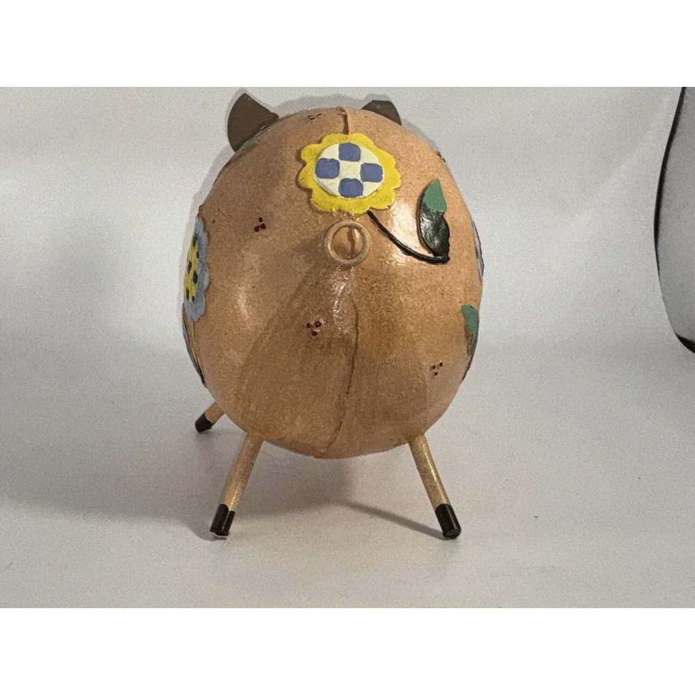 Floral Decorated Pig With Curly Tail And Cute Ears Made Of Metal?